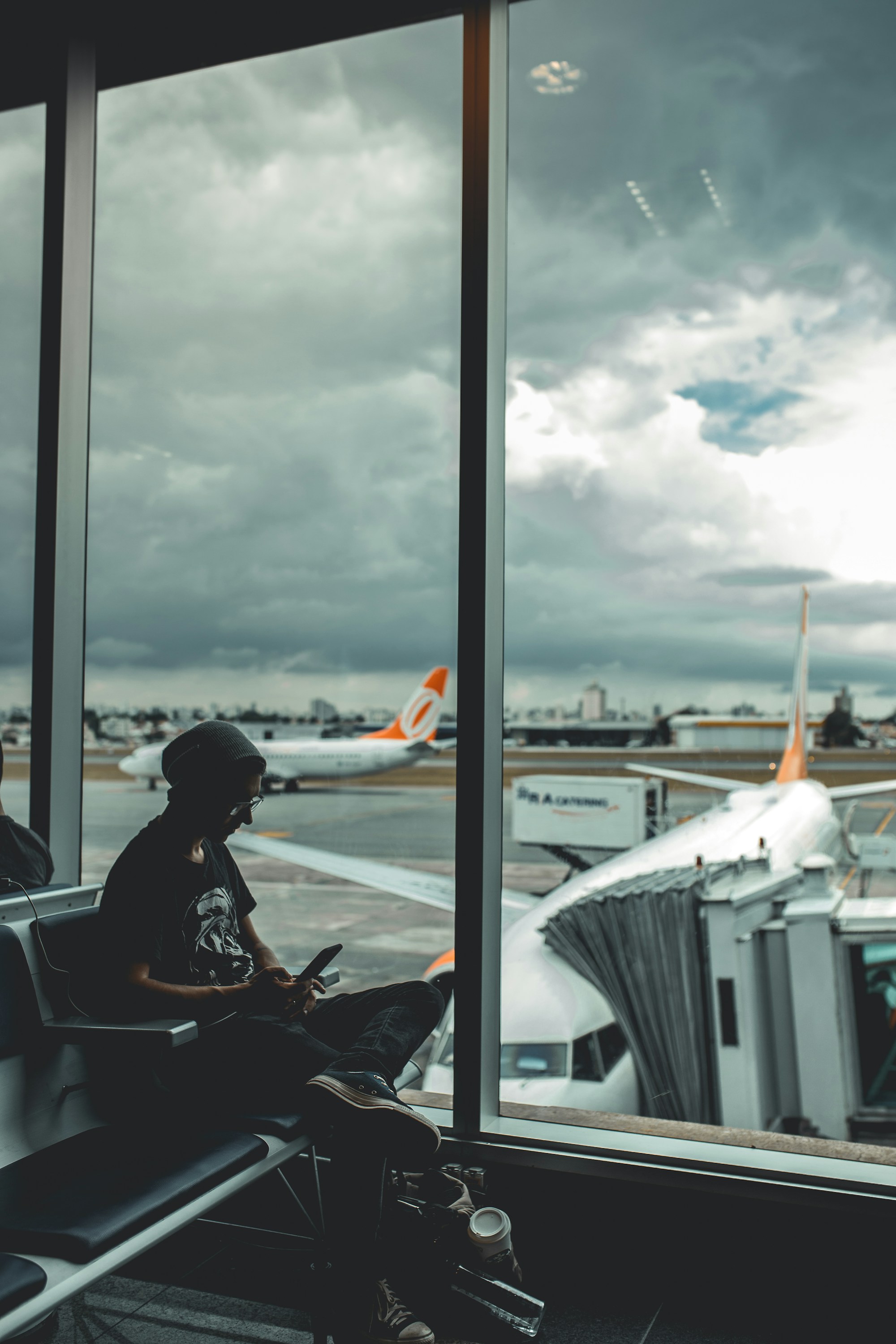 Traveler on laptop at airport gate searching for cheap flights