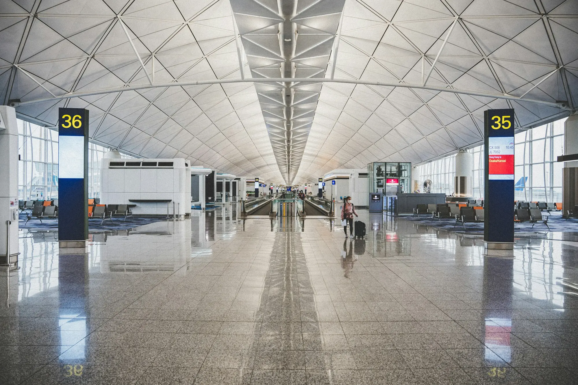 Traveler placing a clear toiletry bag on an airport security conveyor belt