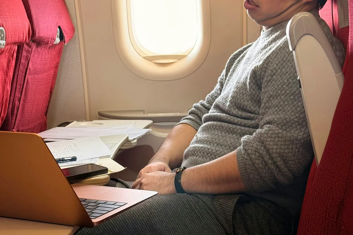 A passenger seated by the window on an airplane